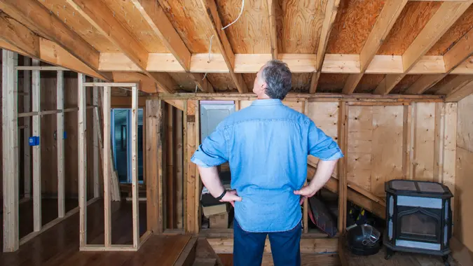 Man looking over recently done work on home addition.