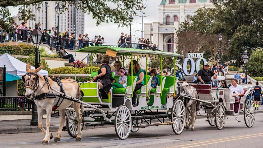 New Orleans, Louisiana / USA - February 17, 2019: A family enjoys a horse drawn carriage ride through Jackson Square in the French Quarter.