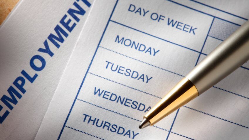 A pen lying on a form showing a blank weekly work schedule.