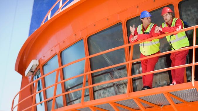 40-44 years, balcony, capetown, caucasian, co-worker, collaboration, color image, construction, construction worker, cooperation, copy space, coveralls, day, engineer, explaining, front view, full length, gesturing, hard-hat, horizontal, industry, leaning, listening, low angle view, man, mature adult, mature men, nautical vessel, occupation, outdoors, partner, people, photography, planning, protection, protective workwear, railing, reflective clothing, reflector-vest, safety, ship, ship's bridge, standing, sunny, talking, teamwork, three quarter length, two people, viewing, worker, working, working together, young adult, young men, 20-24 years