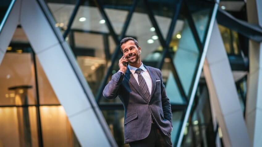 successful business man talking on phone in city