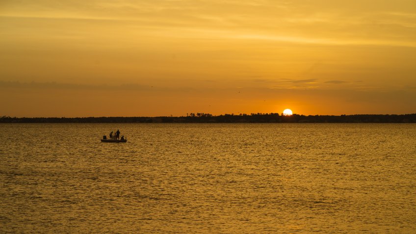 Sunset and boat over Lake Conroe in Texas