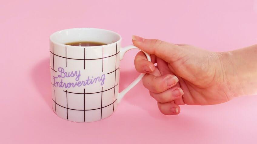 a mug with the words busy introverting inscribed on it