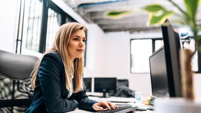 Close-up image of a businesswoman working on the computer.