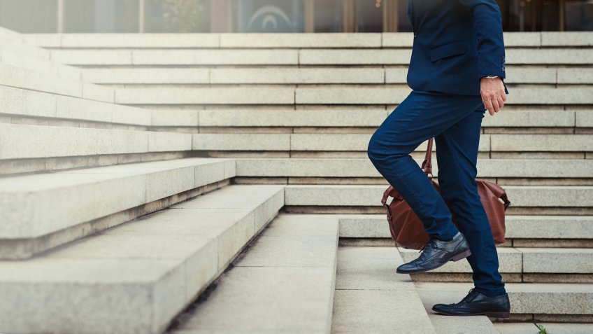 Profile shot of an unidentifiable businessman walking to work in the city.