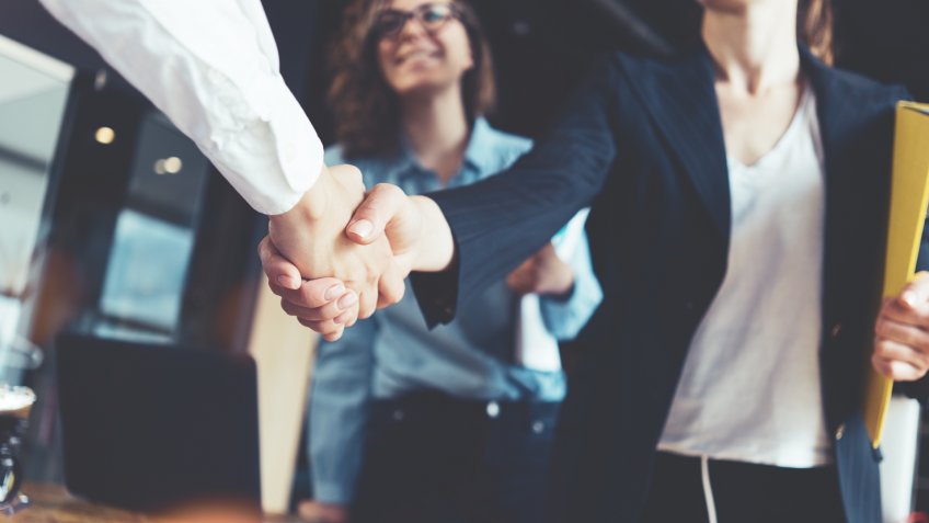 business woman shaking hands with employer