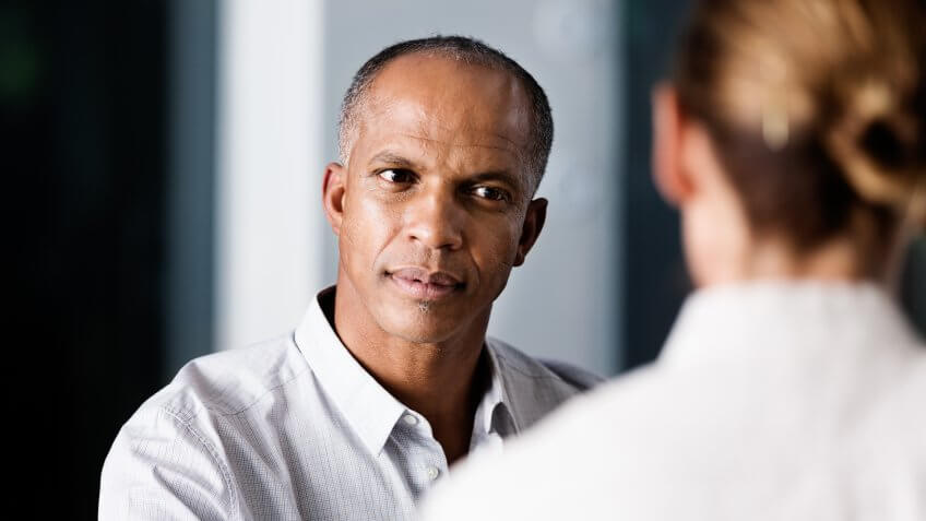 Businessman looking at female colleague in office.