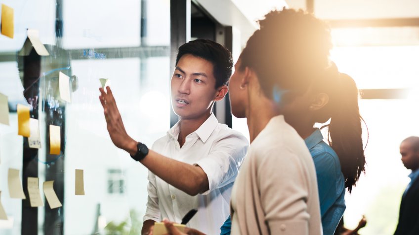 Shot of a group of young businesspeople having a brainstorming session in a modern office.