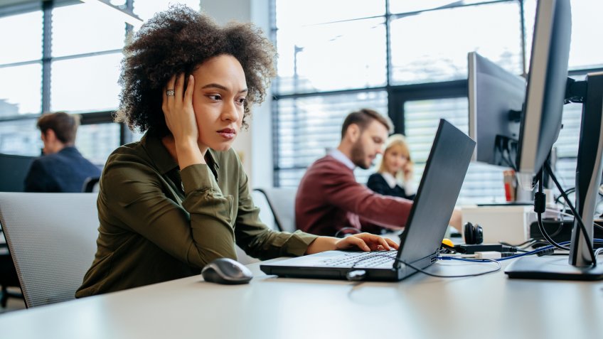 Cropped shot of a exhausted businesswoman sitting in front of her computer in an office.