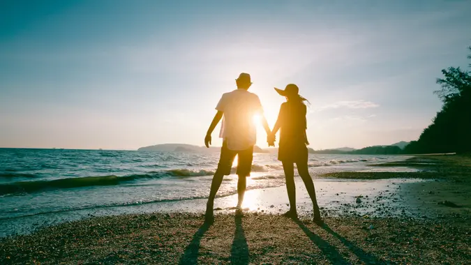 couple holding hands on the beach