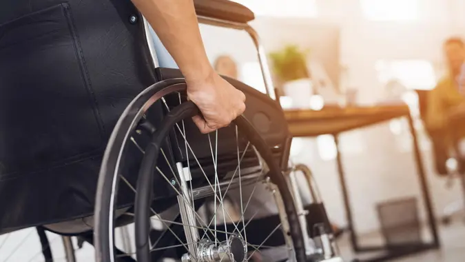 A disabled man is sitting in a wheelchair.