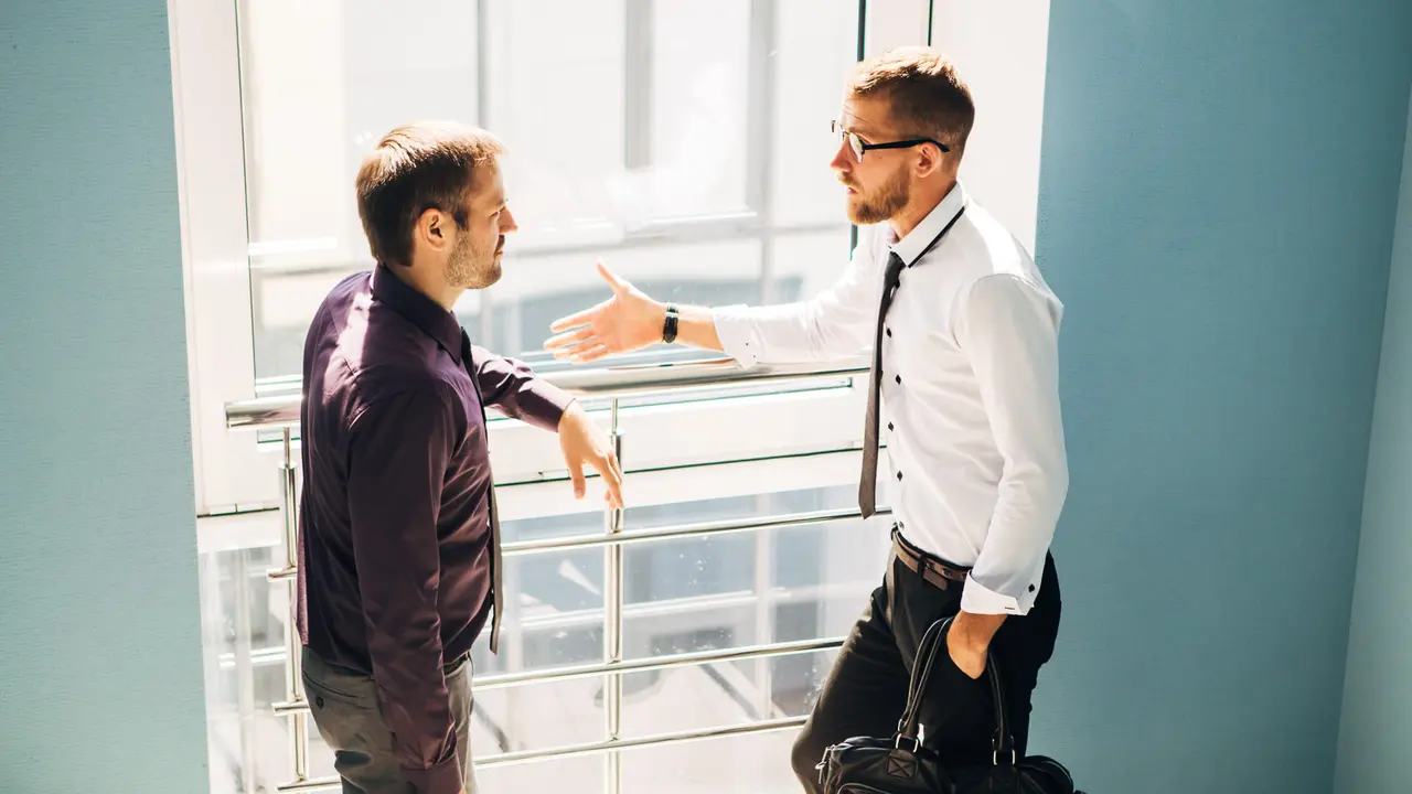 employee explaining to his boss why he will be quitting his job