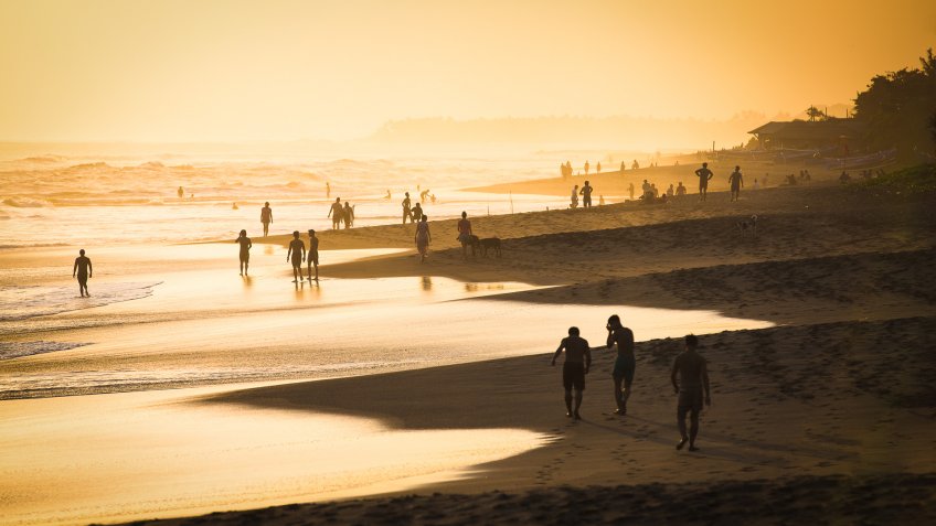 exotic travel destination Kuta Beach at sunset in Bali Indonesia
