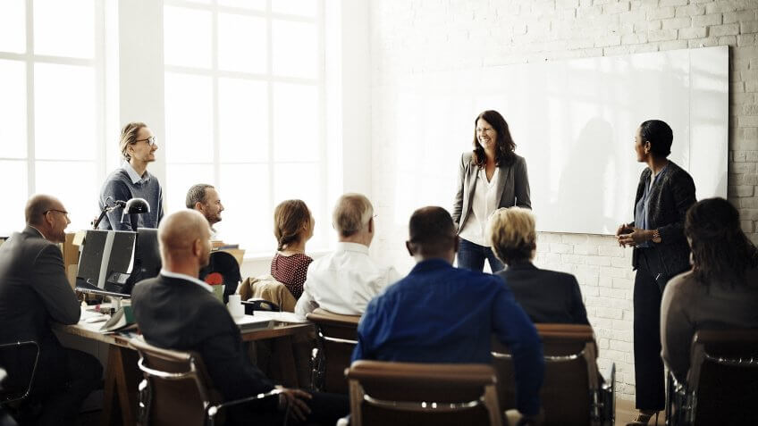 female company leader giving all-hands presentation