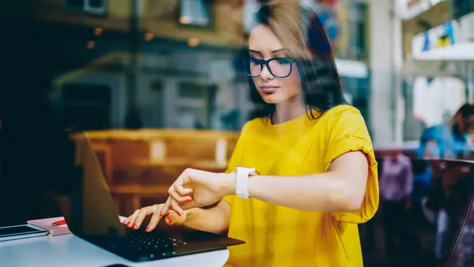 girl checking her smartwatch for time