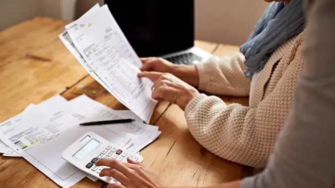 Cropped view of a senior woman receiving help with her finances from her granddaughter.