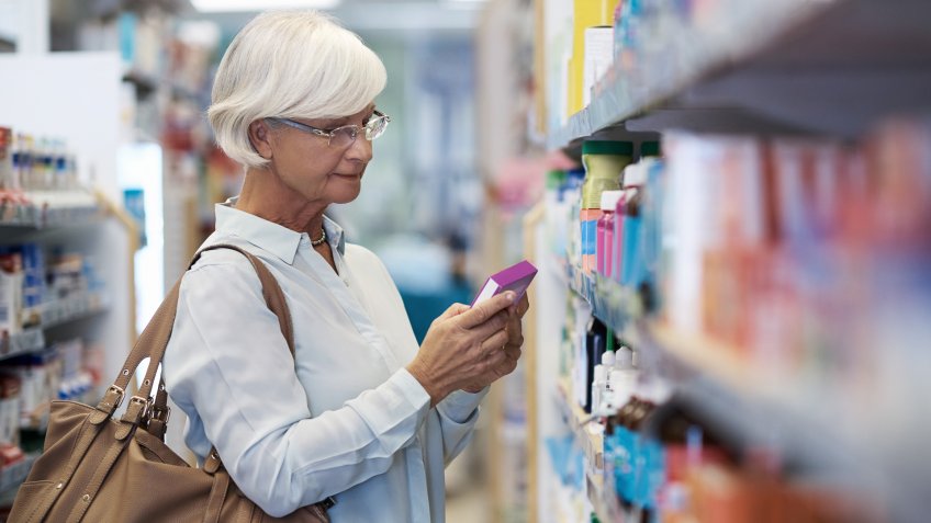 Shot of an elderly woman looking at products in a pharmacy.