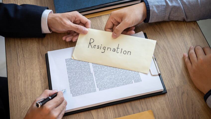 handing over a letter of resignation