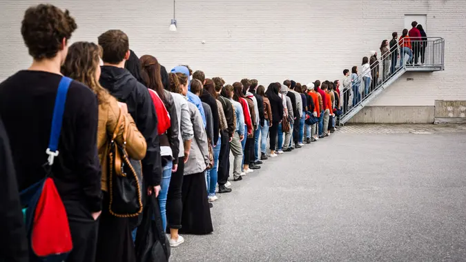 large group of people waiting in line for retirement