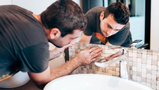 man remodeling bathroom with tile man remodeling bathroom with tile