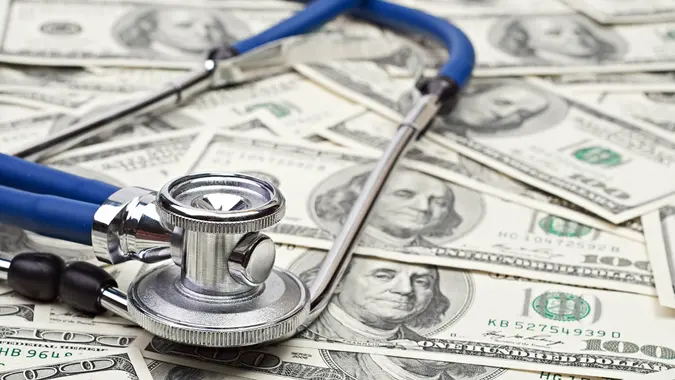 heap of dollars with stethoscope.