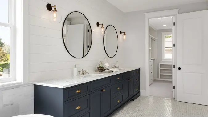 modern remodeled master bathroom with vanity sconce