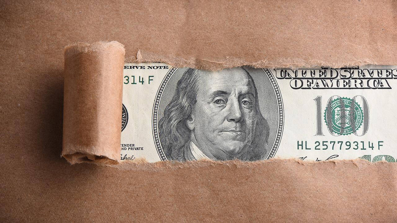 Benjamin Franklin macro through torn paper - Image.