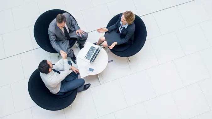 Three business people sealing a business deal.