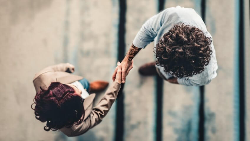 Male Manager Shaking Hands With Female Applicant.