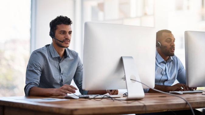 Shot of call centre agents working in an office.