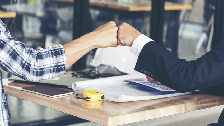 two coworkers bumping fists after closing out project