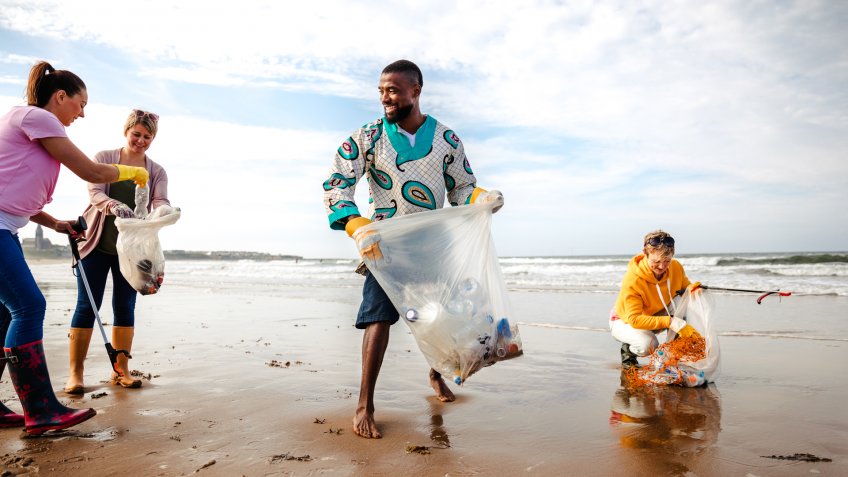 Collecting rubbish off a beach.