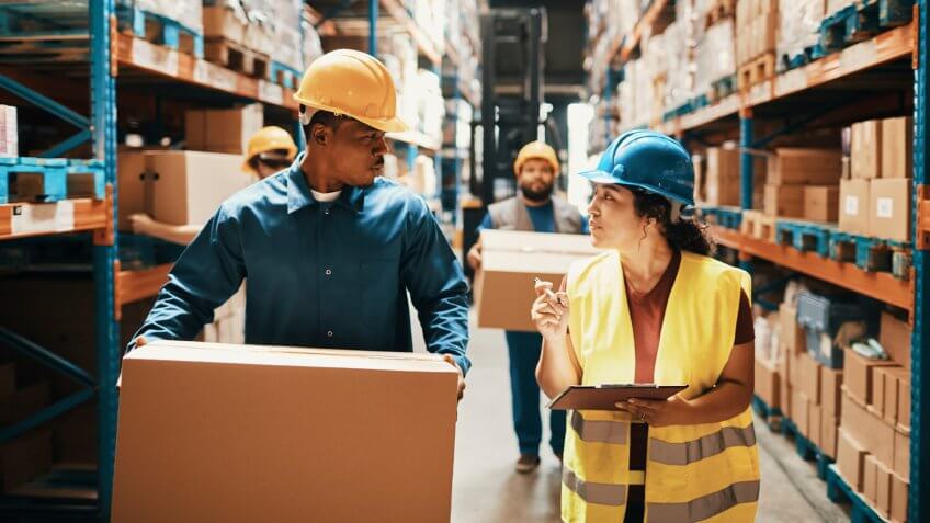 Close up of a group of workers working in a warehouse.