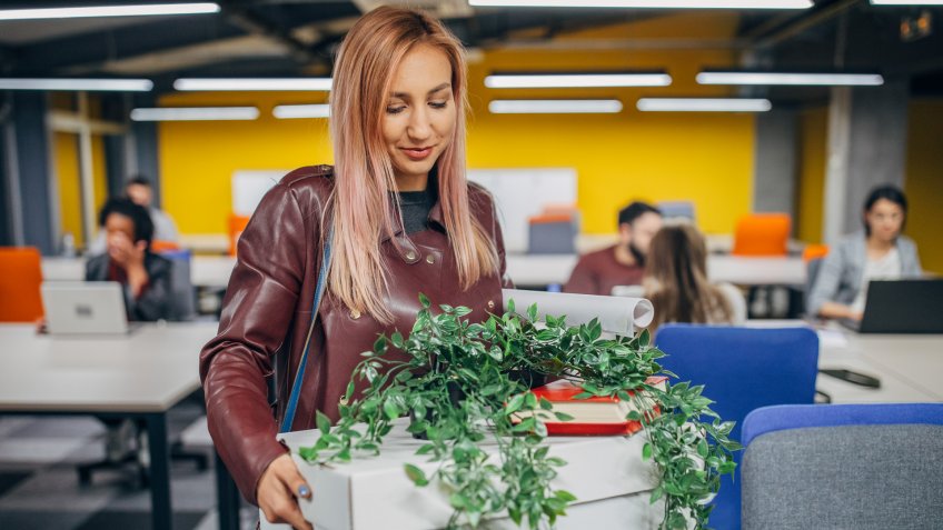 Young woman standing in the office starting new job.