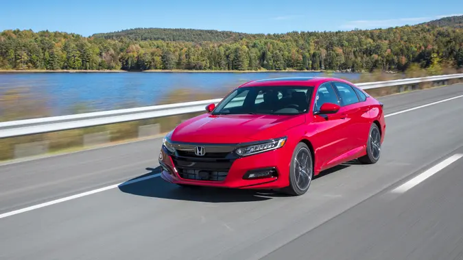 A red 2019 Honda Accord Sport 2.0T driving on an open road