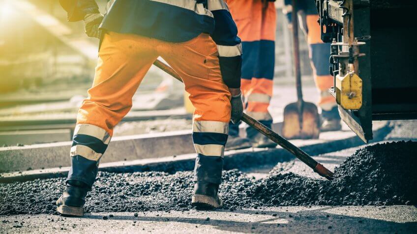 Teamwork, Group of workers on a road construction, team of people at work.