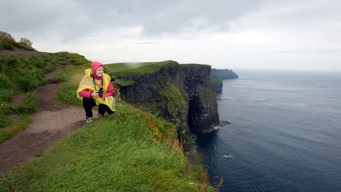 Woman on Cliffs of Moher, Ireland, Europe.