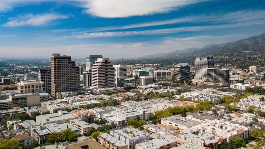 Downtown Glendale, California skyline, aerial view with condo/apartment buildings in the foreground, and with the Verdugo Mountains and other parts of the San Fernando Valley in the distance.
