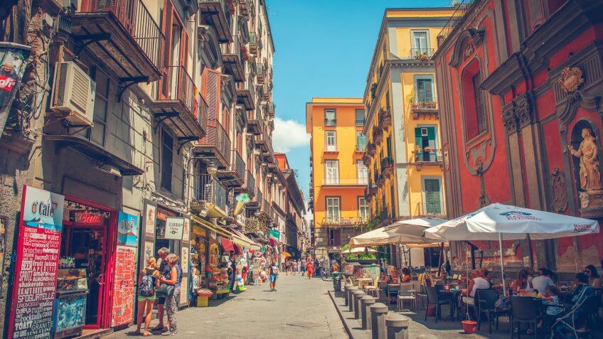 Naples, Italy - July 28, 2015: Narrow street in the center of Naples, with its traditional architecture, cafes and shops.