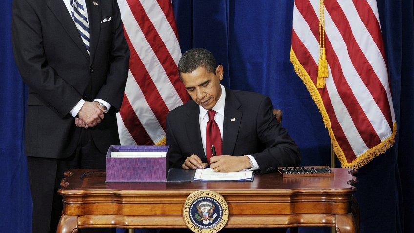 President Barack Obama signs the American Recover and Reinvestment Act Bill in February 2009