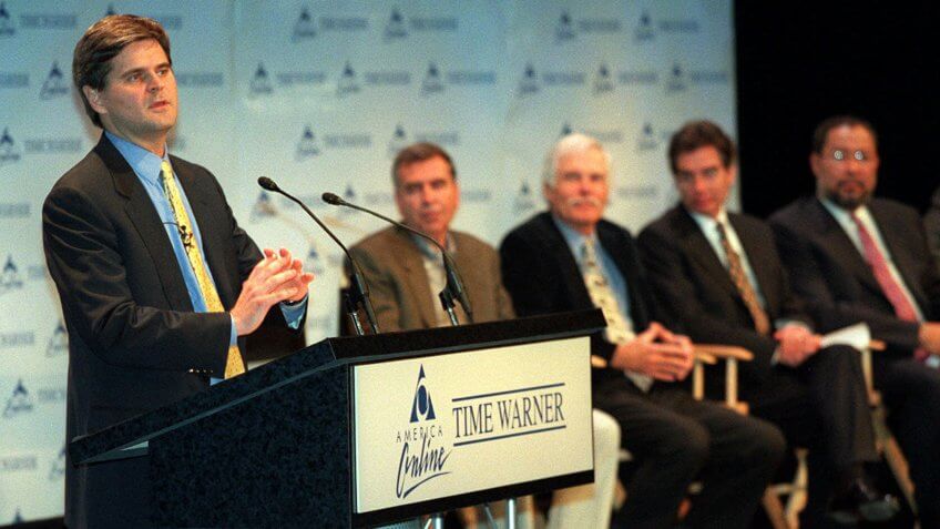 Steve Case, America Online's chairman and chief executive, left, addresses the news conference about the Time Warner and AOL merger