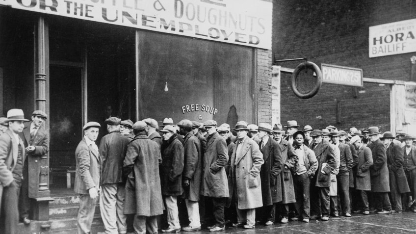 Unemployed men queued outside a depression soup kitchen opened in Chicago by Al Capone