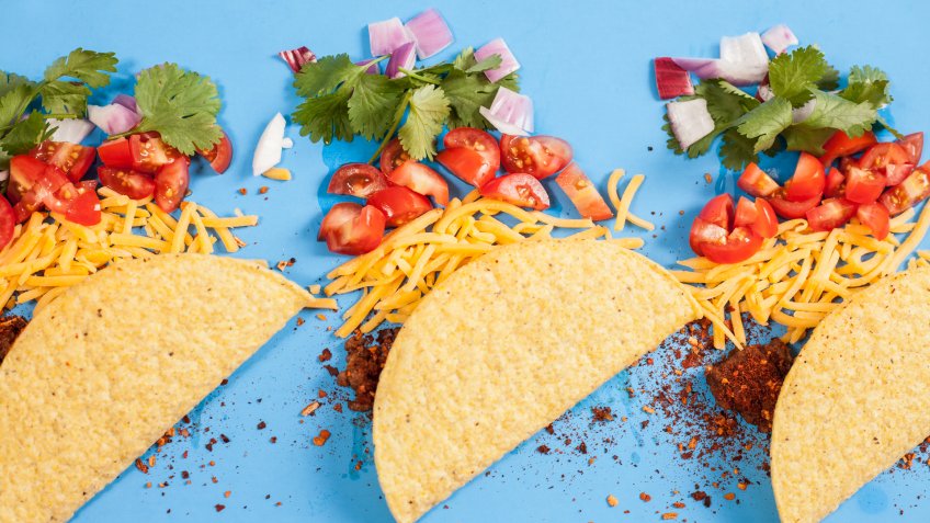 Mexican food! Delicious crunchy beef tacos and ingredients arranged in knolling organization.