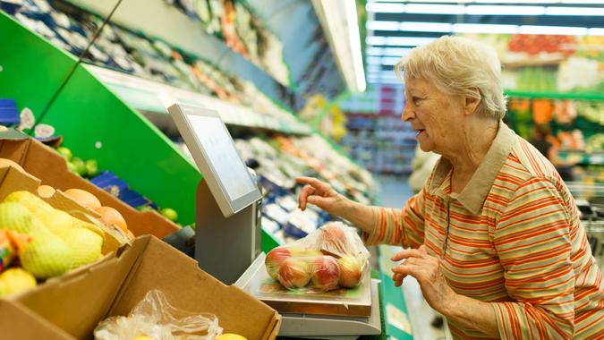 elderly woman purchasing fresh produce with SNAP