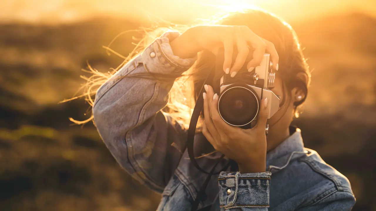female photographer capturing sunset