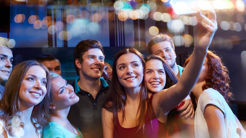 girl taking selfie at party while she is sick from work