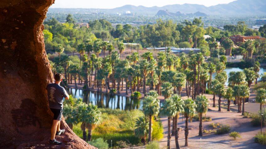 Guy looking the view from hole in the rock in Phoenix Arizona.