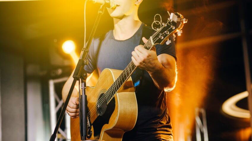 live musician singing and playing guitar