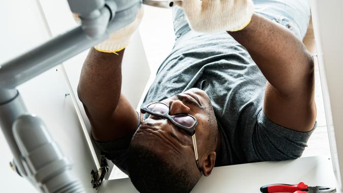 male handyman working on plumbing repair