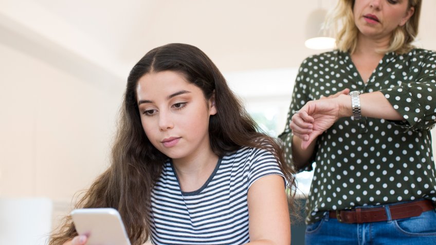 Mother Arguing With Teenage Daughter Over Use Of Mobile Phone.
